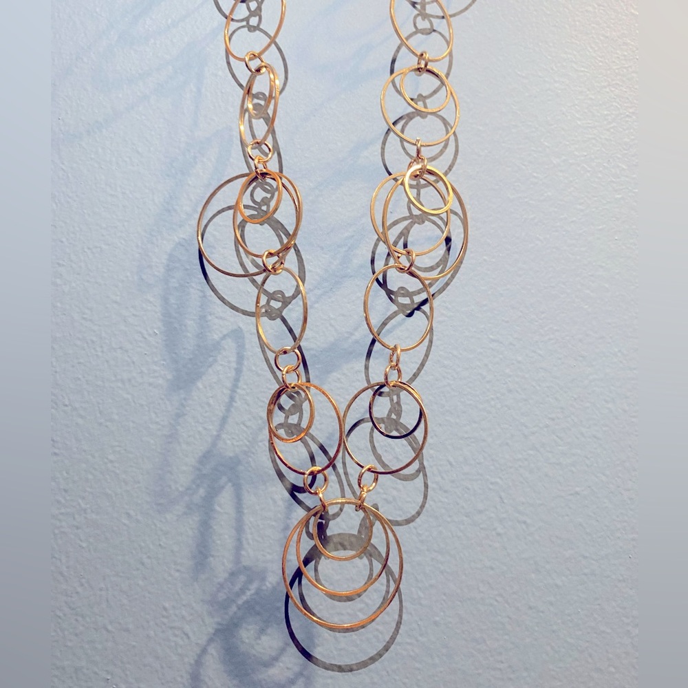 Long gold necklace with matching earrings